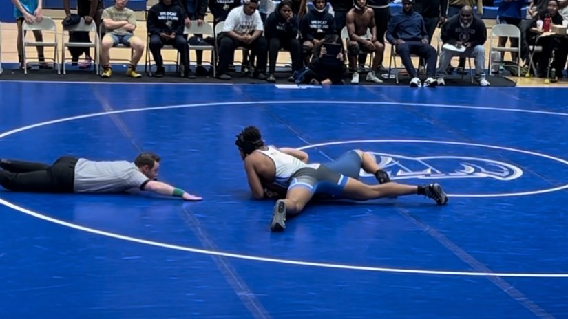 Bin successfully pins his opponent in his junior year
