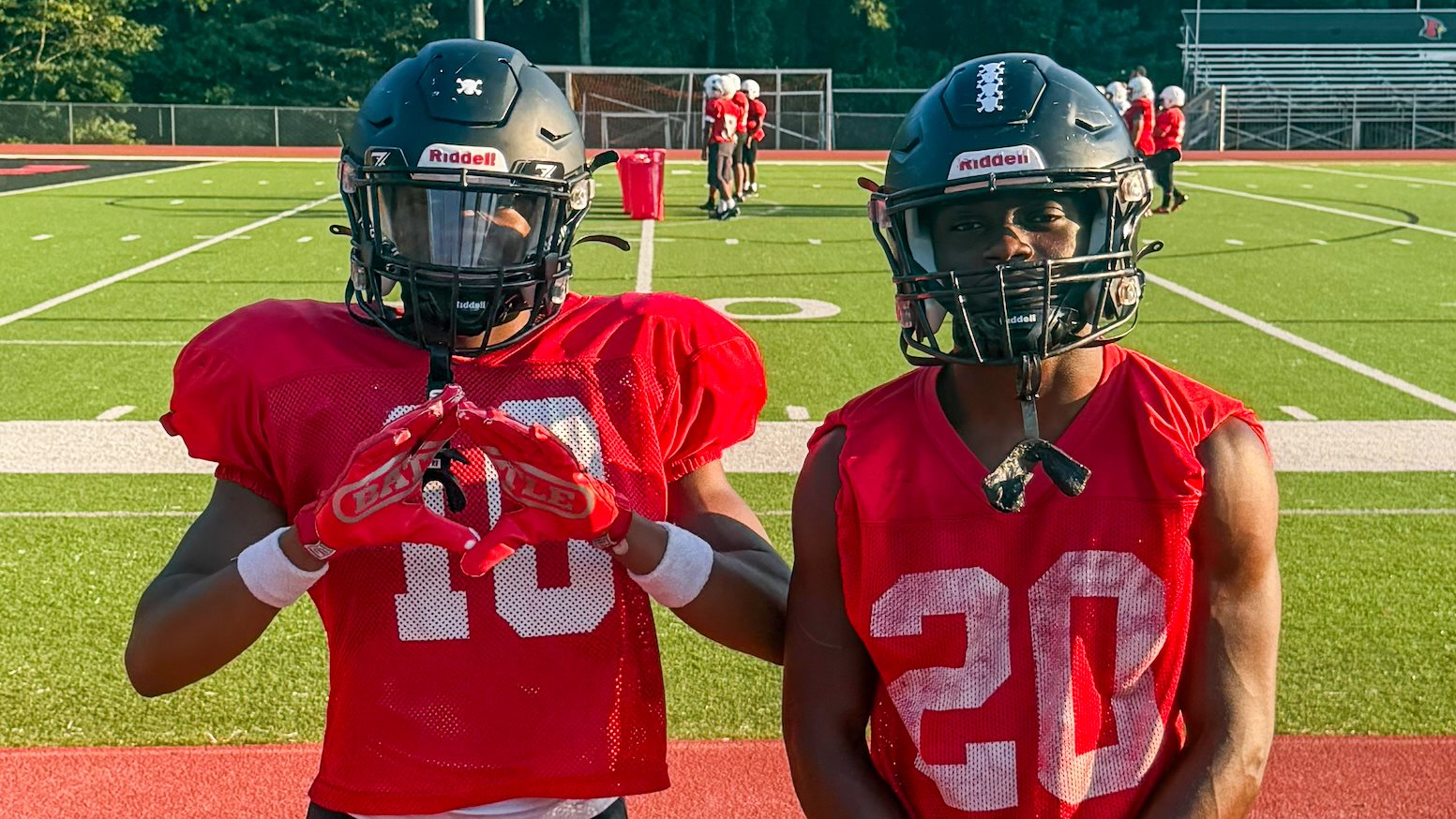 Osborne's Khalen (10) and Khalani (20) poses for photos after practice