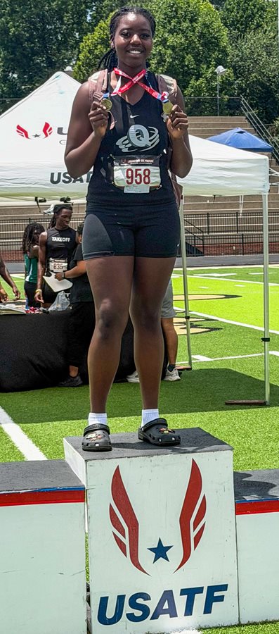 Pebblebrook's Jonae' Holder stands atop the podium showing off her two gold medals
