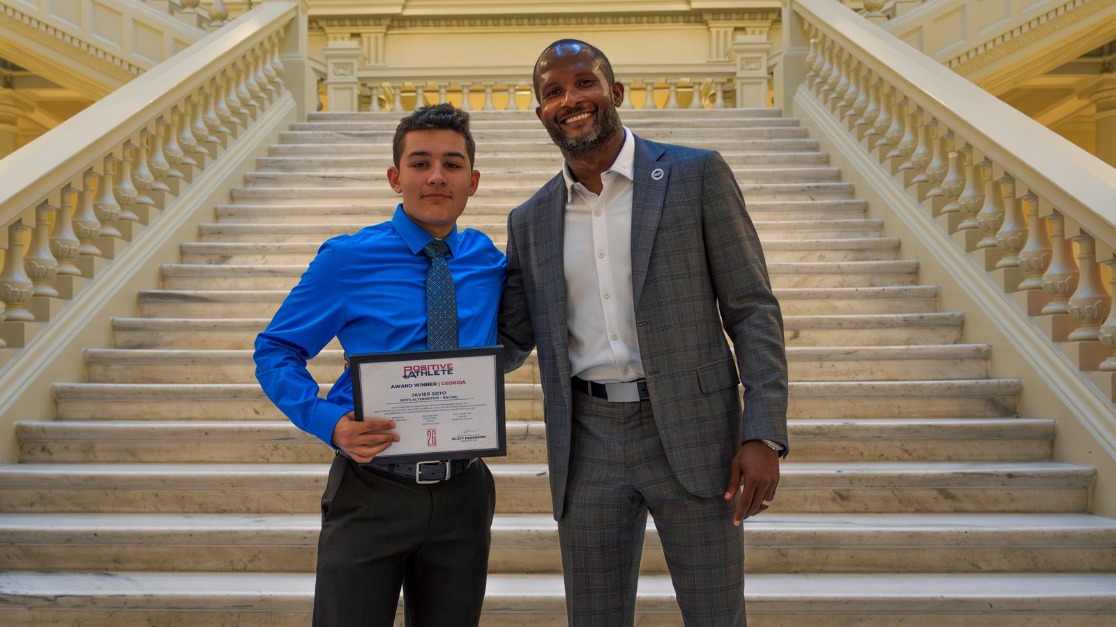 Walton's Javier Soto is presented with his Positive Athlete certificate from Champ Bailey