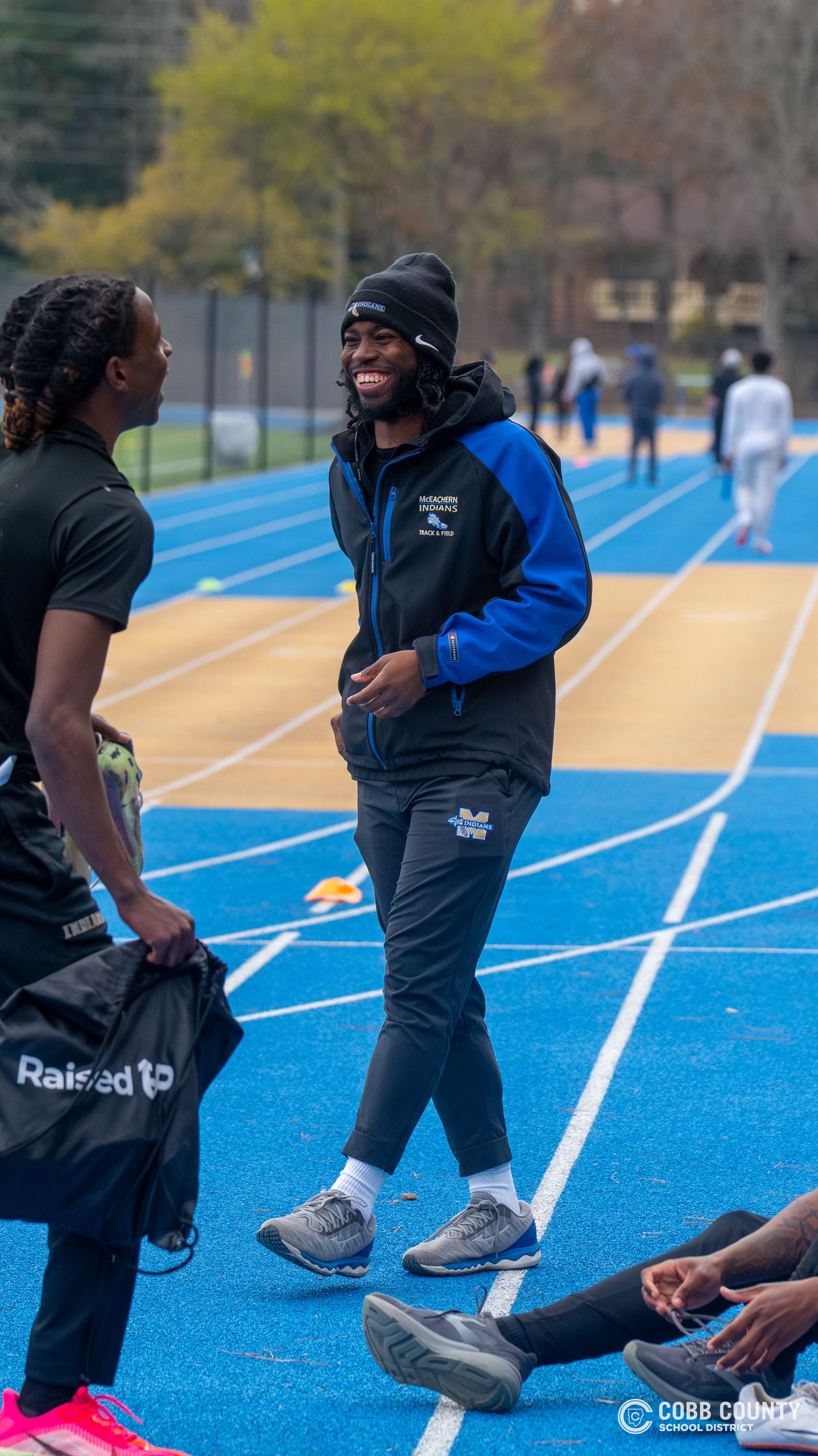 Coach Freeze shares a laugh with the McEachern T&F team