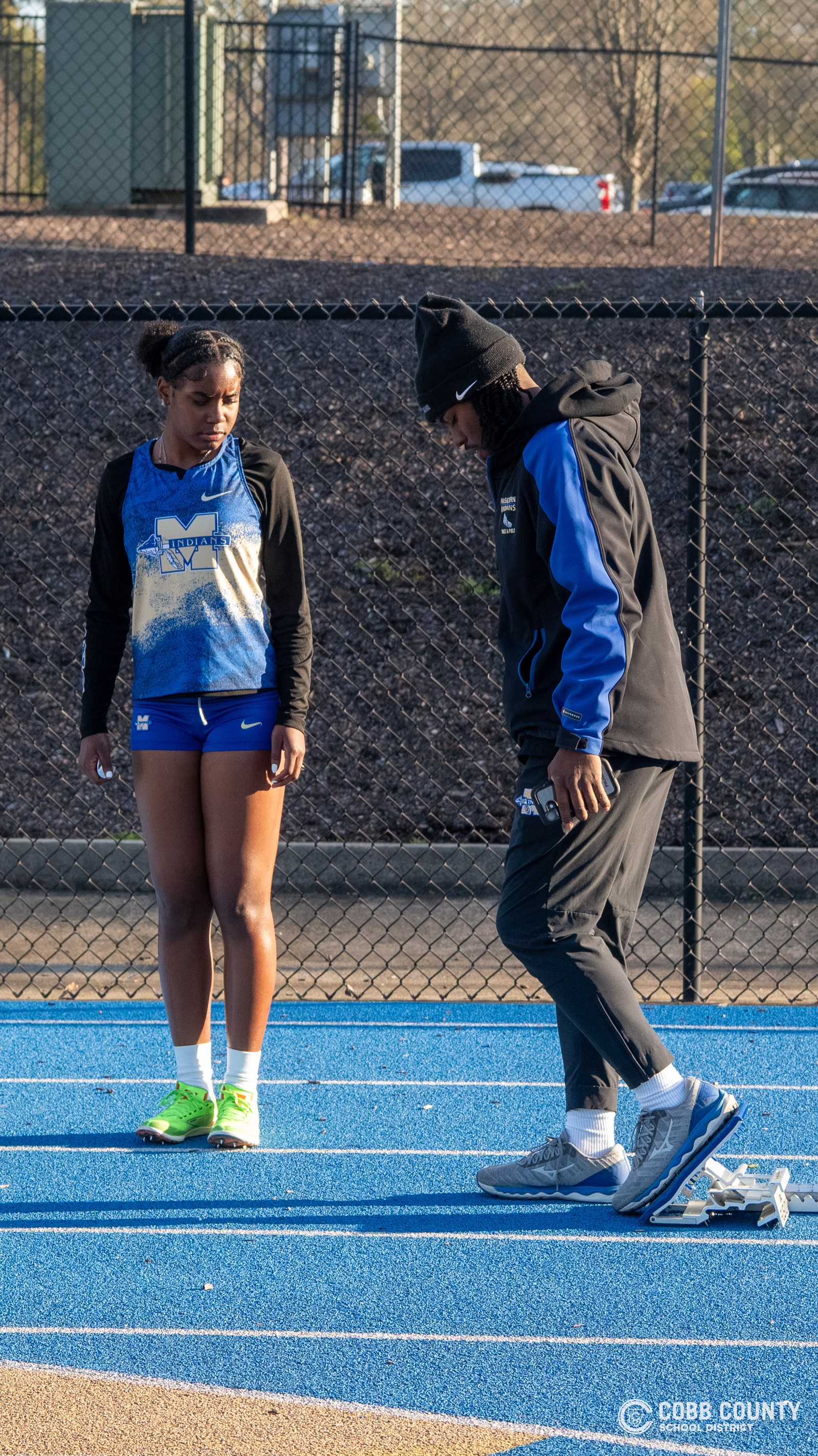 Nigel Talton works with a runner on how to set up in the blocks