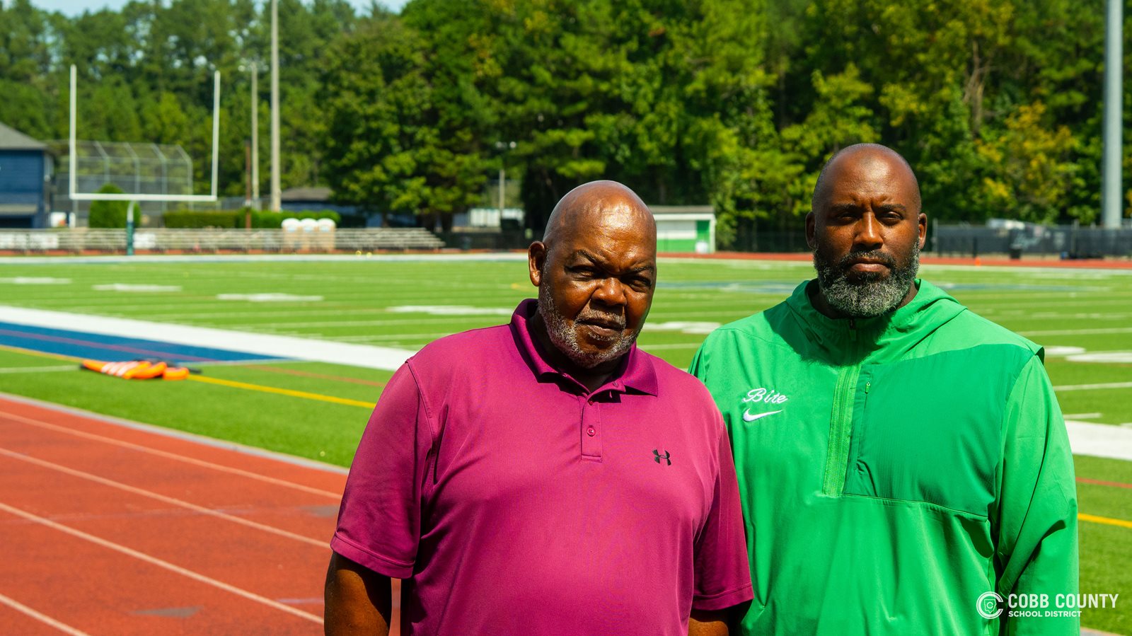 Harrison custodian Dwight Randall poses with football coach Luqman Salam