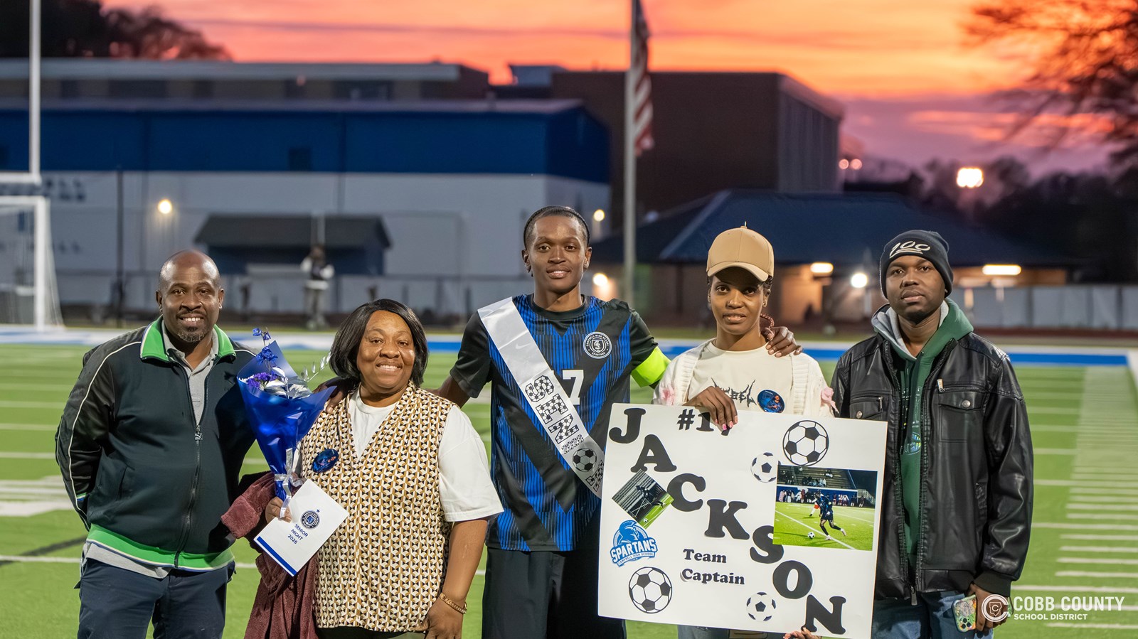 Jackson poses with family members on Senior Night at Campbell
