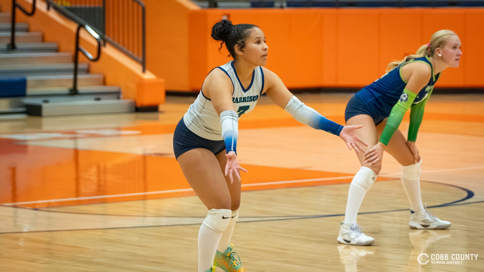 Harrison's Lilah Anderson readies to receive the serve