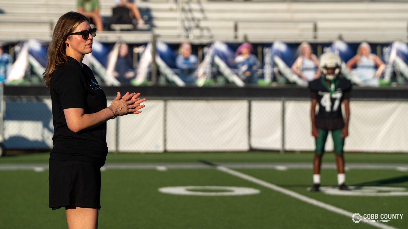 Coach Jarvis takes in the defensive signals before interpreting to Larenzo