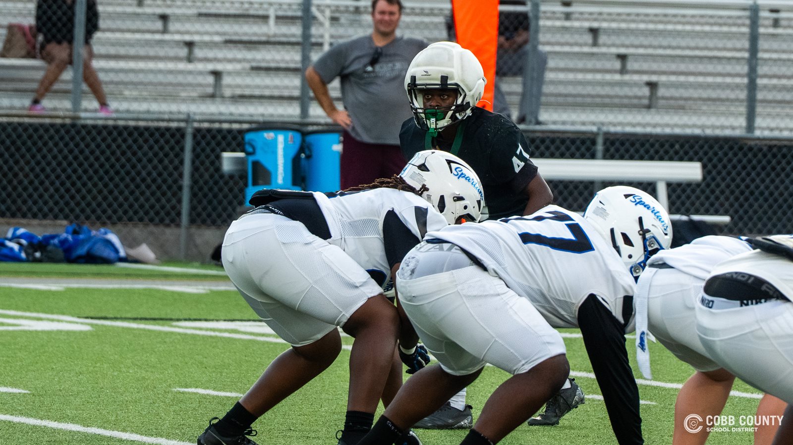 Larenzo Parker peers over the offensive line from his linebacker position