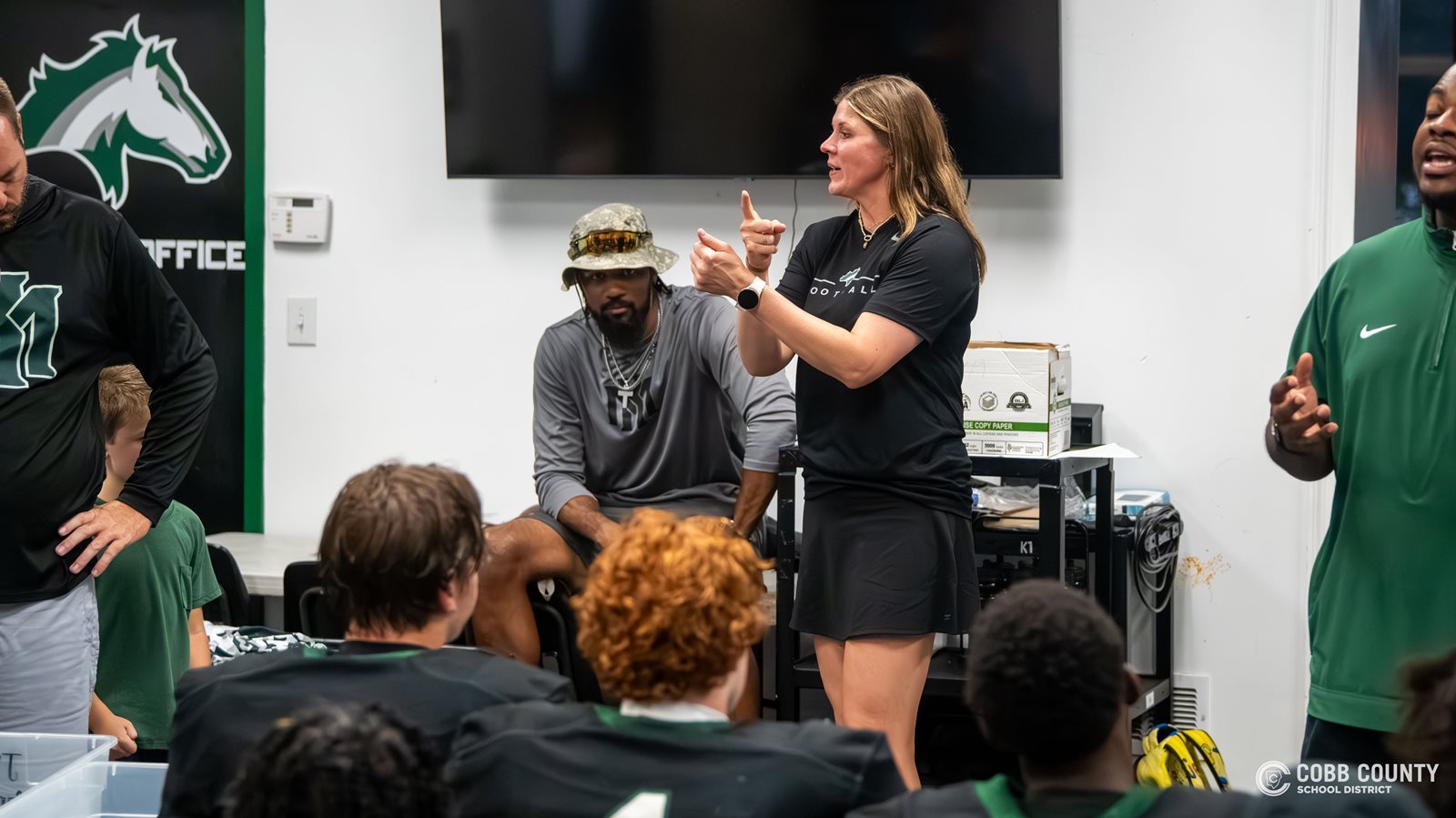 Coach Jarvis interprets during the halftime of a football game