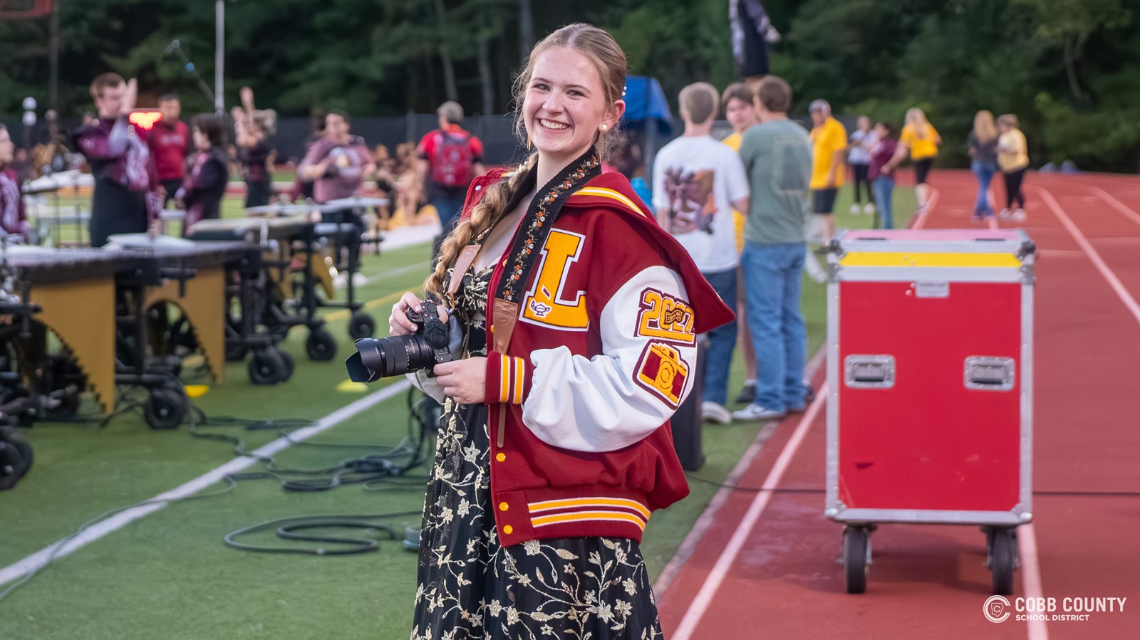 Audrey Moss smiles in front of the camera