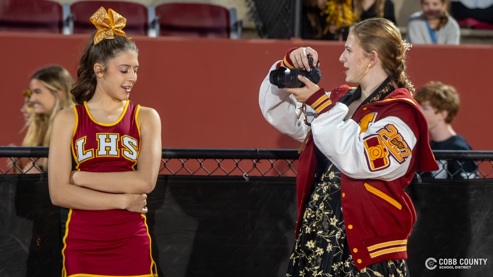 Audrey Moss chats with cheerleader