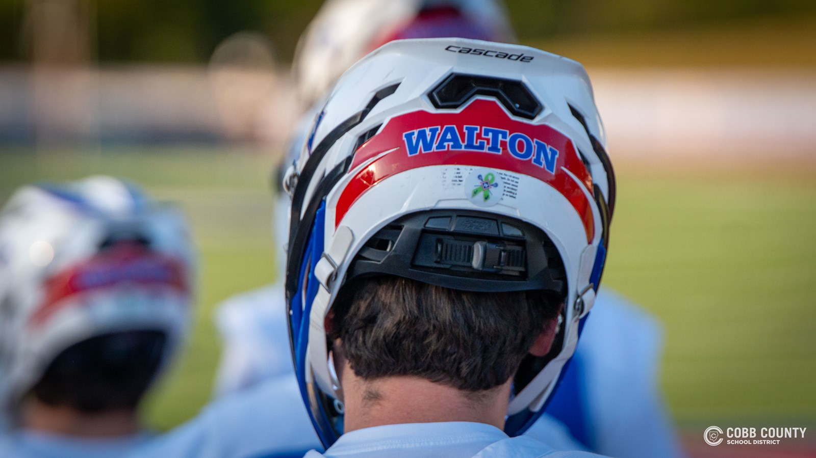 A Walton player takes the field with the Jackson Jefcoat sticker visible