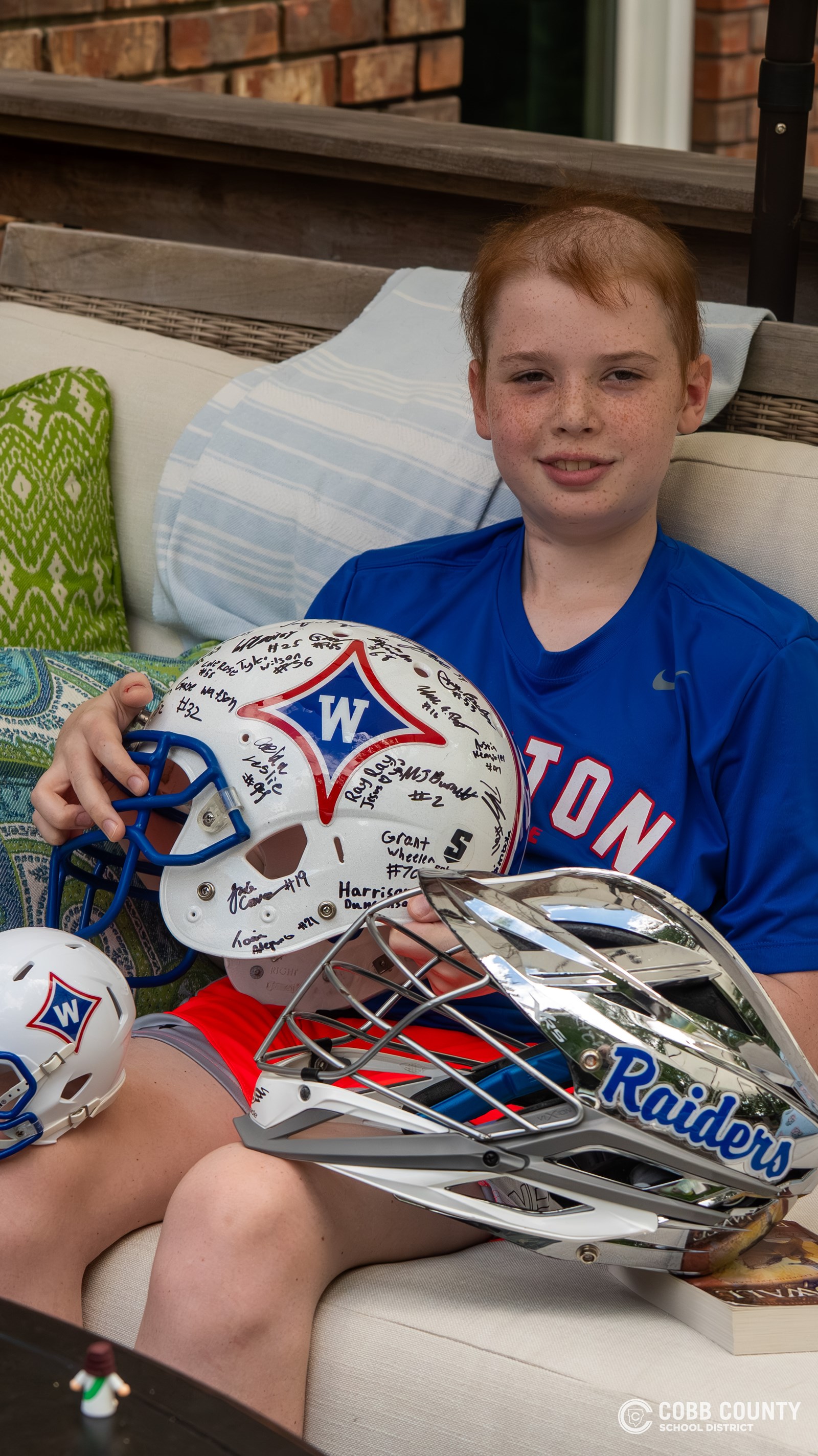 Jackson poses with gifts from Walton football and lacrosse