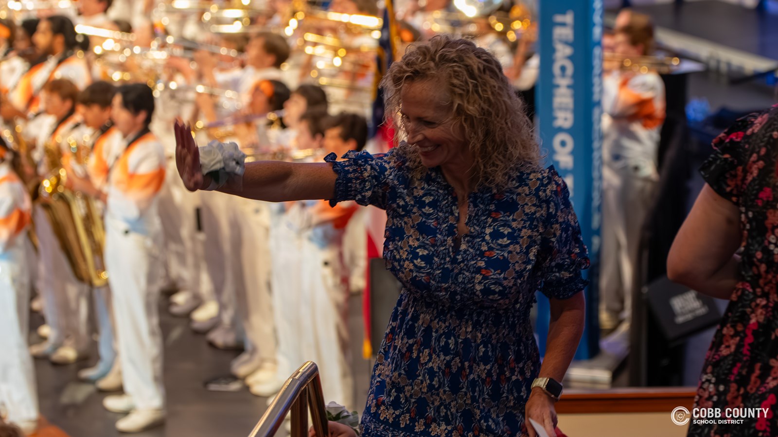 Teacher waving to students