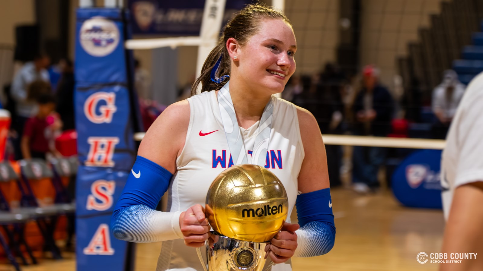 Walton sophomore Janie Myers holds the championship trophy