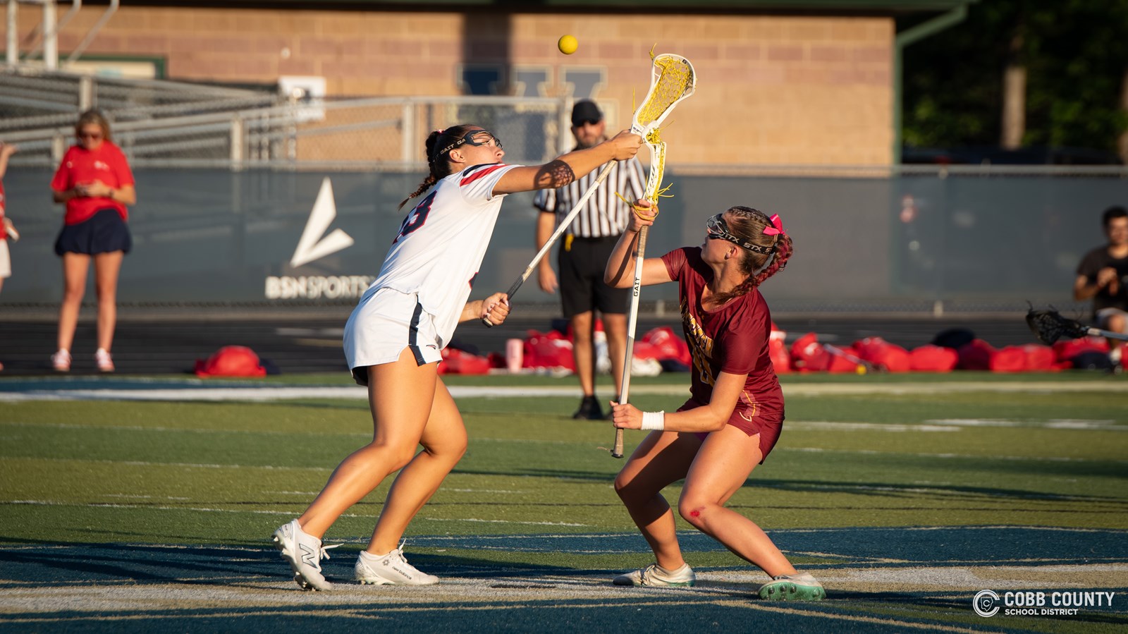 Lassiter's Sophie Hortman battles for the faceoff