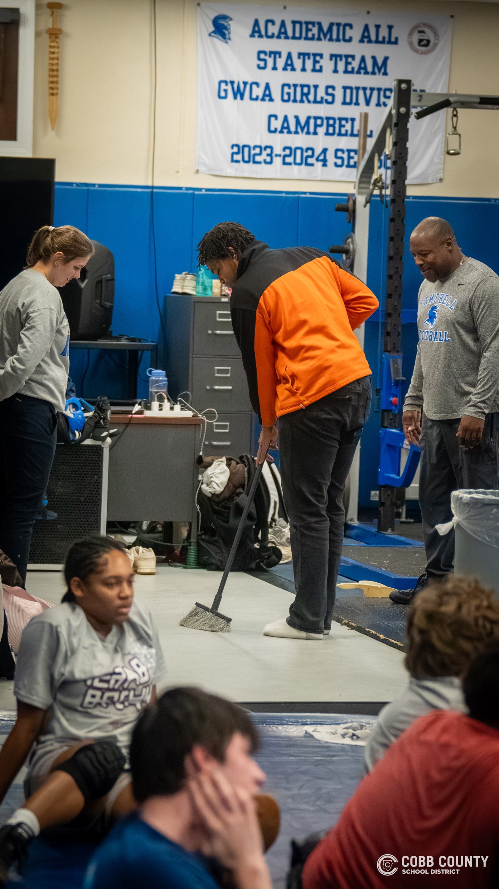 Bin sweeps the weight room during practice