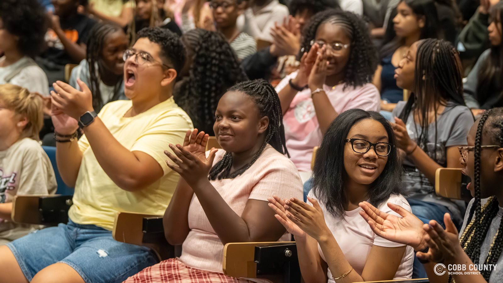 Ebony Collier's students celebrate their teacher being named the Cobb Schools MIiddle School Teacher of the Year.