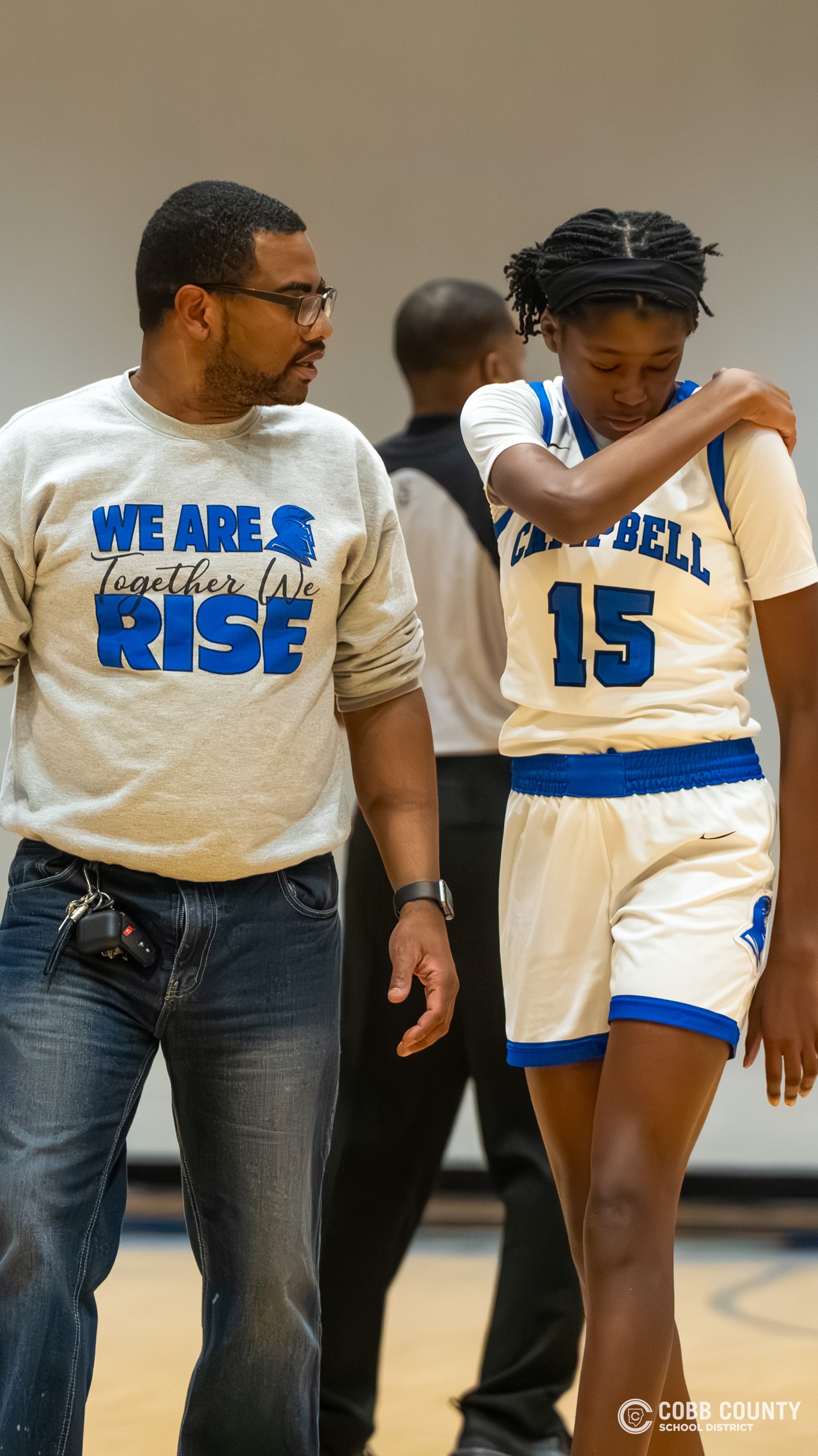 As JV Head Coach, Terrell Johnson checks on an injured player