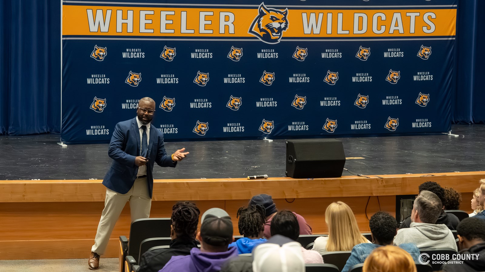 Coach Roland addresses the community