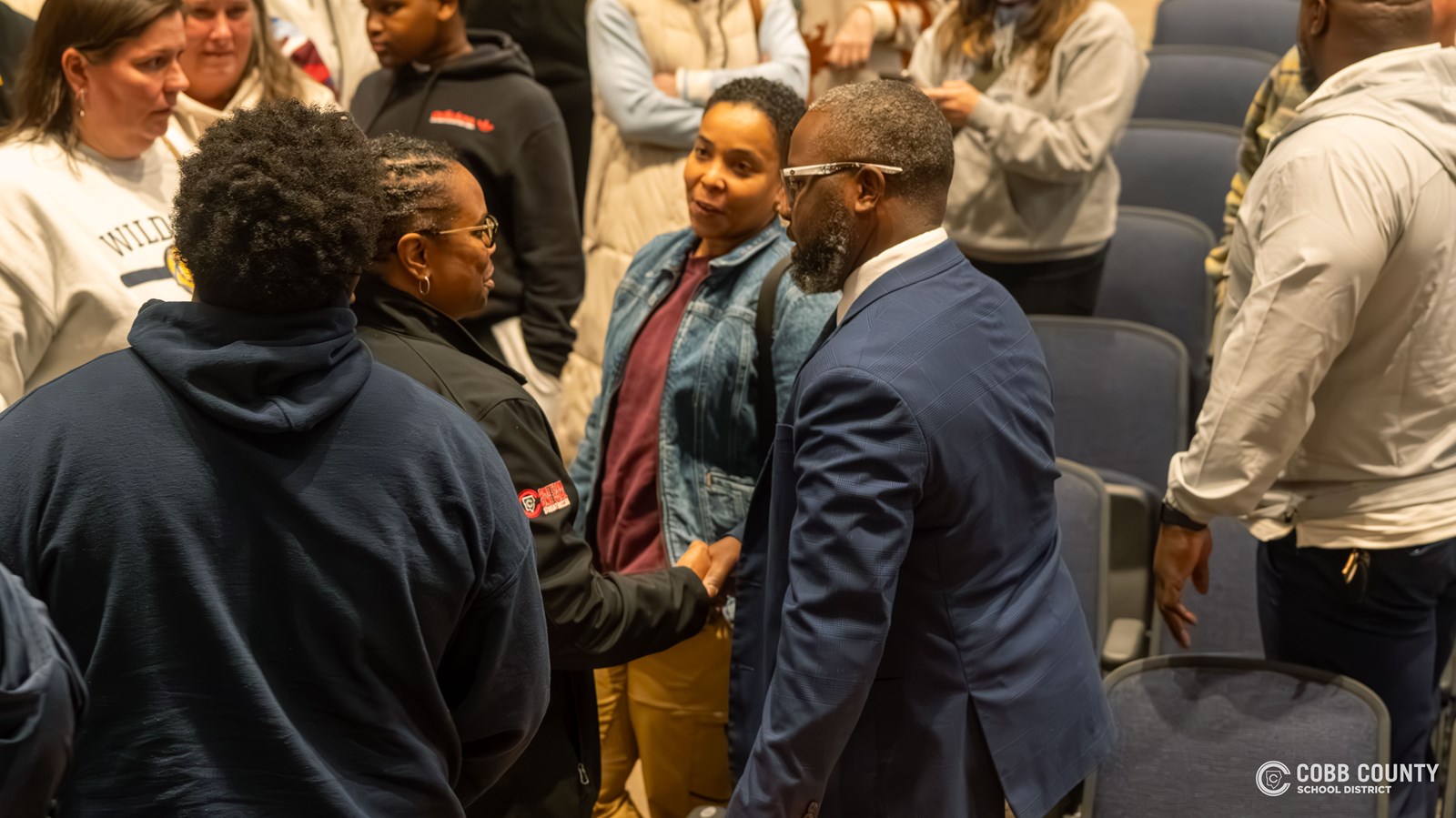 Coach Roland meets attendees one-on-one
