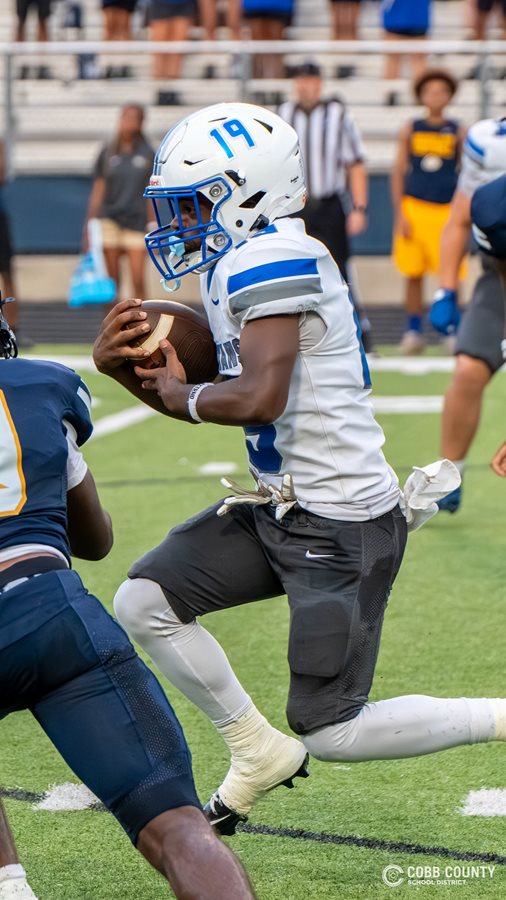 Campbell's Zach Willis carries the ball through the defense