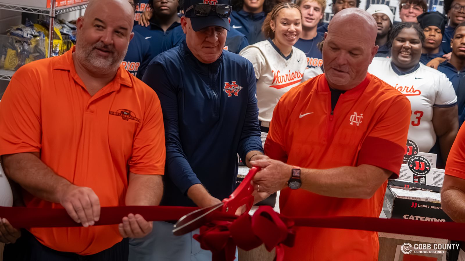 North Cobb principal David Bell and football Head Coach Shane Queen perform the official ribbon cutting duties