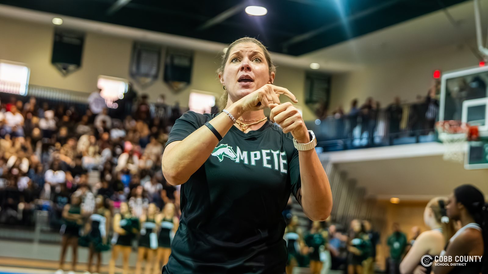 Coach Jarvis interprets during a KMHS pep rally