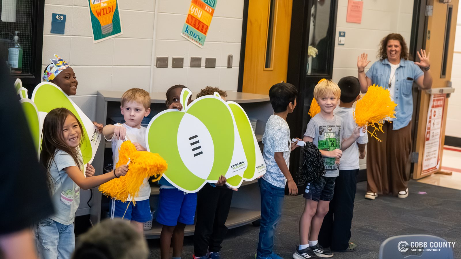 Mrs. Eubanks is surprised by her first-grade students when she walks into the Hayes ES media center