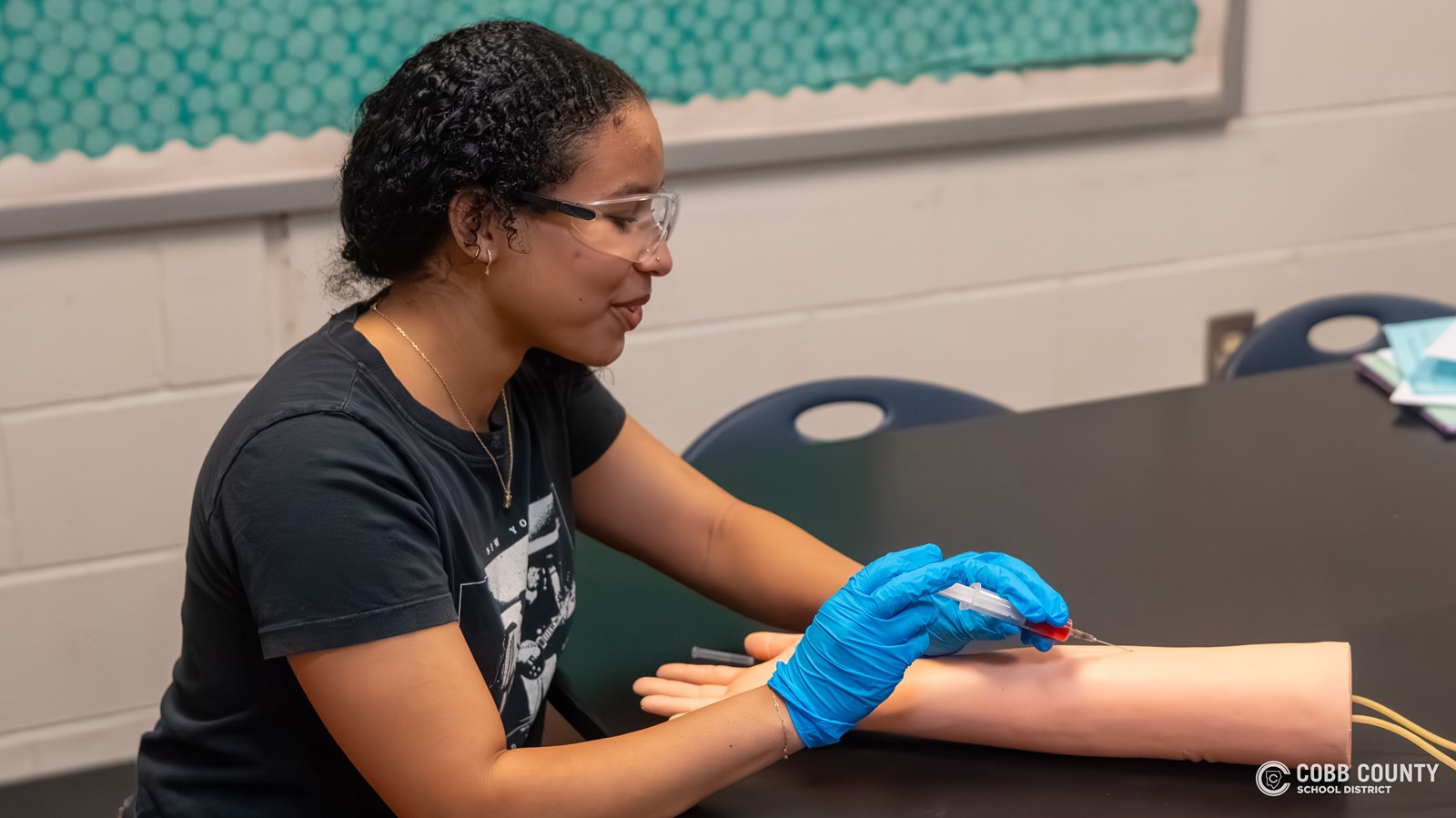 Lilah Anderson practices on an artificial arm