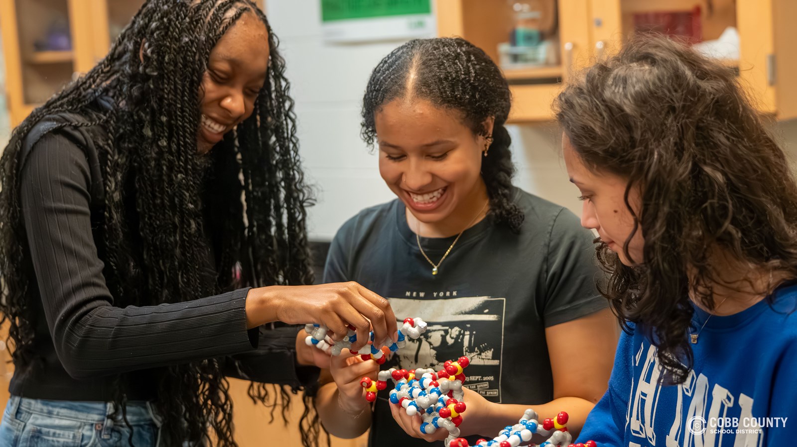 Lilah Anderson (C) building models with Kendall Boone (L) and Avery Dinh (R)
