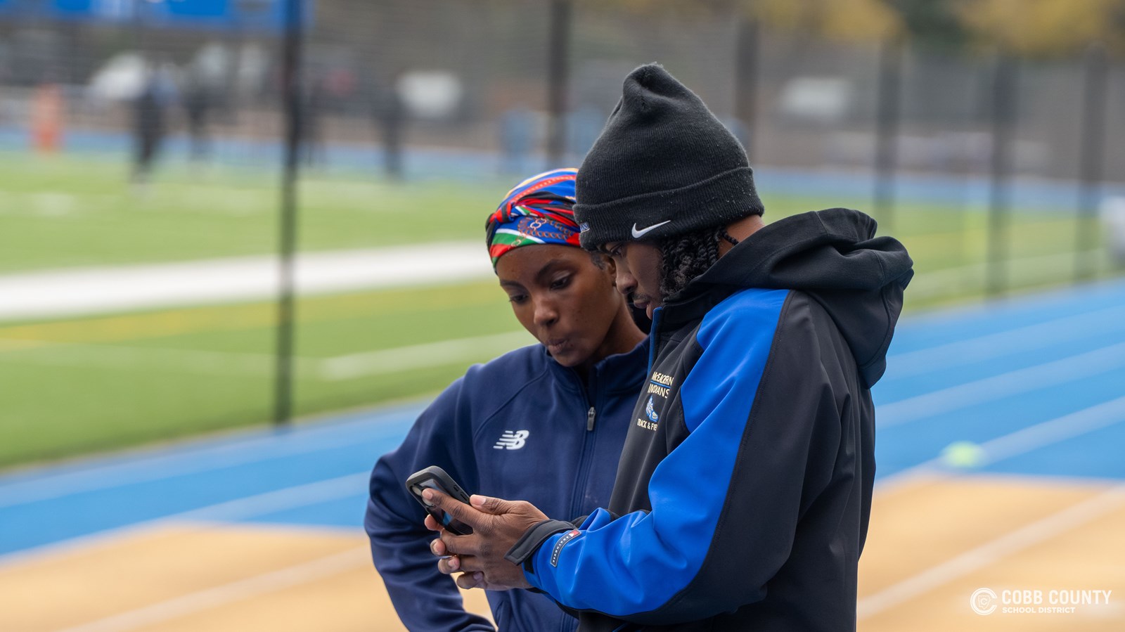Coach Talton goes through the video with a sprinter