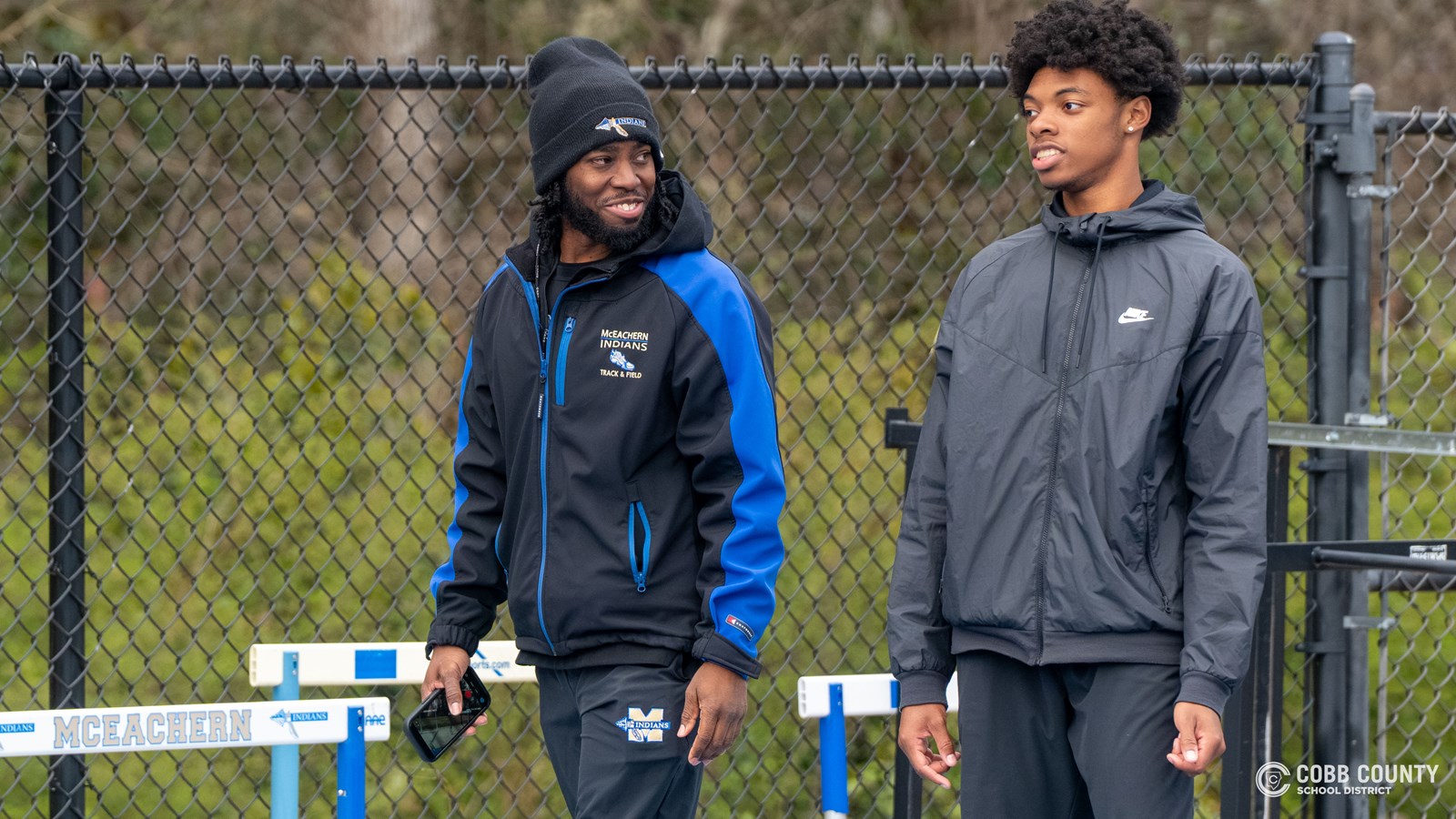 Assistant Coach Nigel Talton shares a smile with a McEachern track athlete