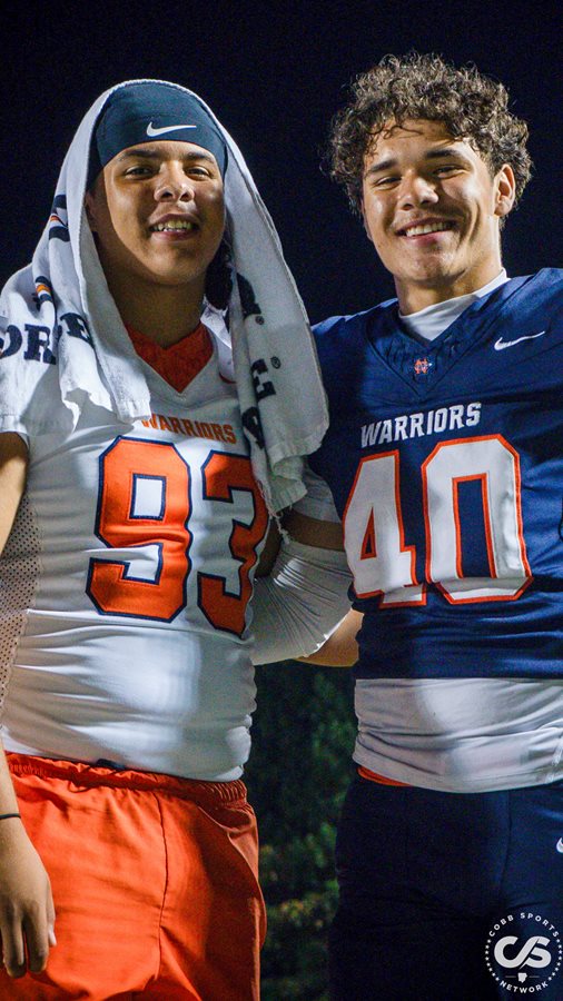 North Cobb's Rameses (93) and Levi (40) Echevarria pose for a pregame photo