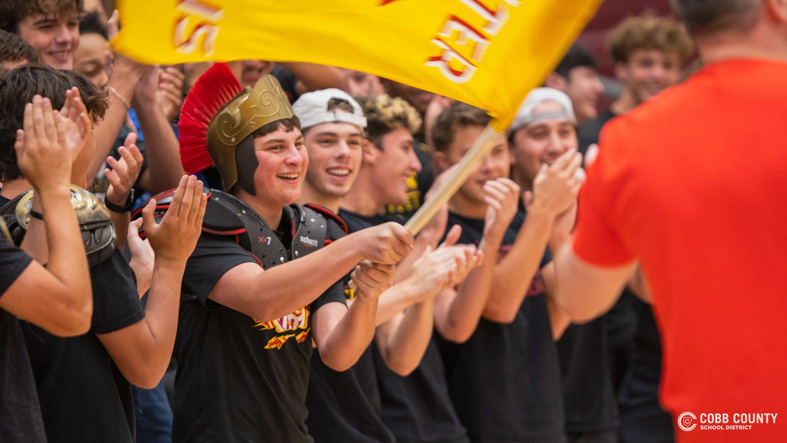 A Lassiter student waves the school flag