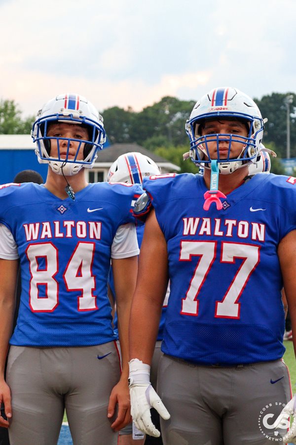 Walton's Caleb (84) and David (77) Silva pose pregame