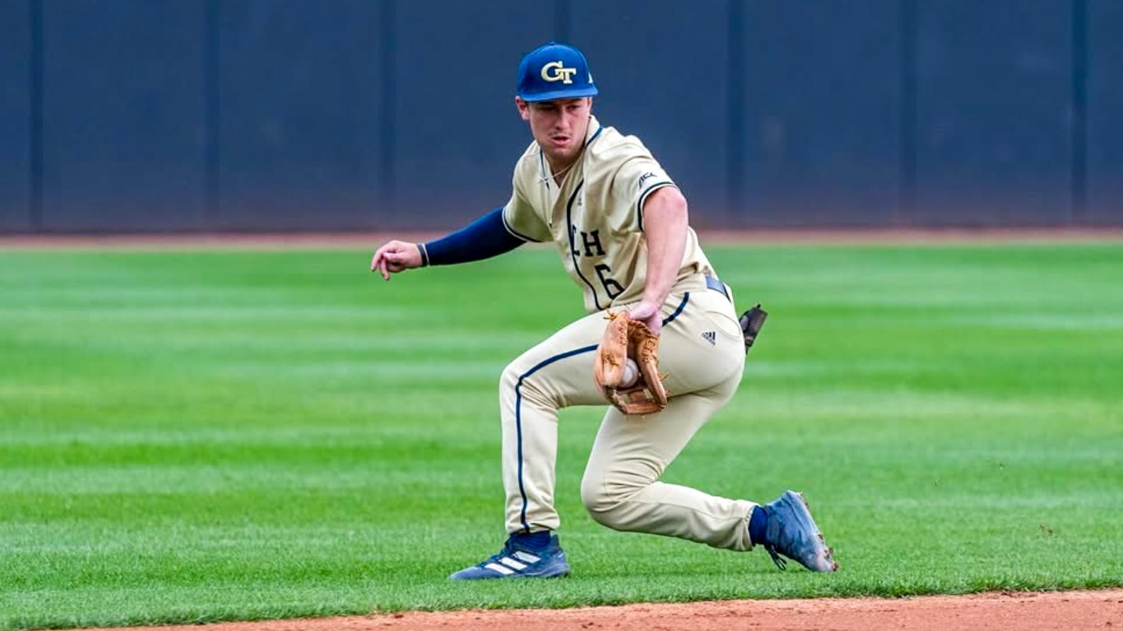 Carson Kerce backhands a grounder for Georgia Tech