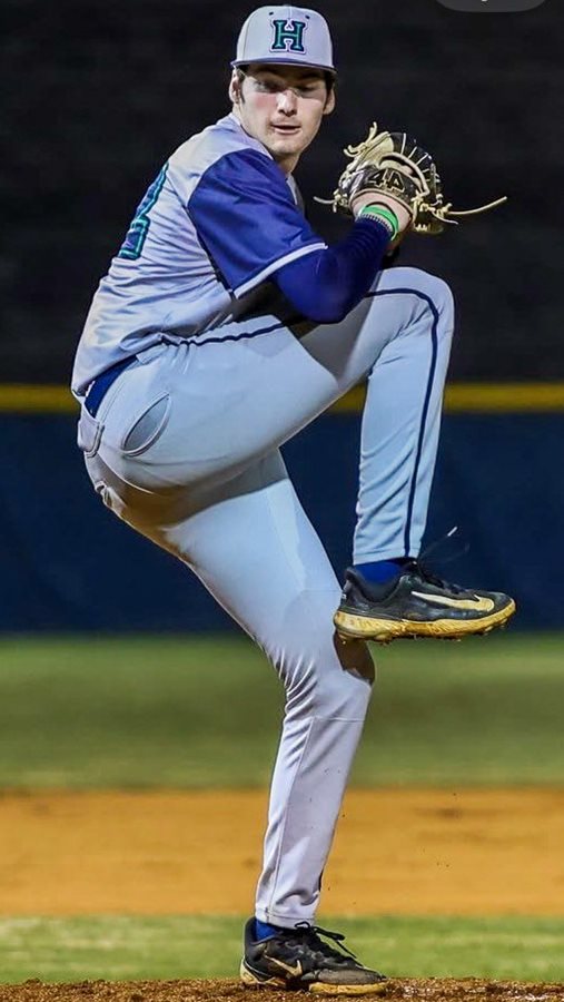 Harrison's Colin White starts his pitching motion