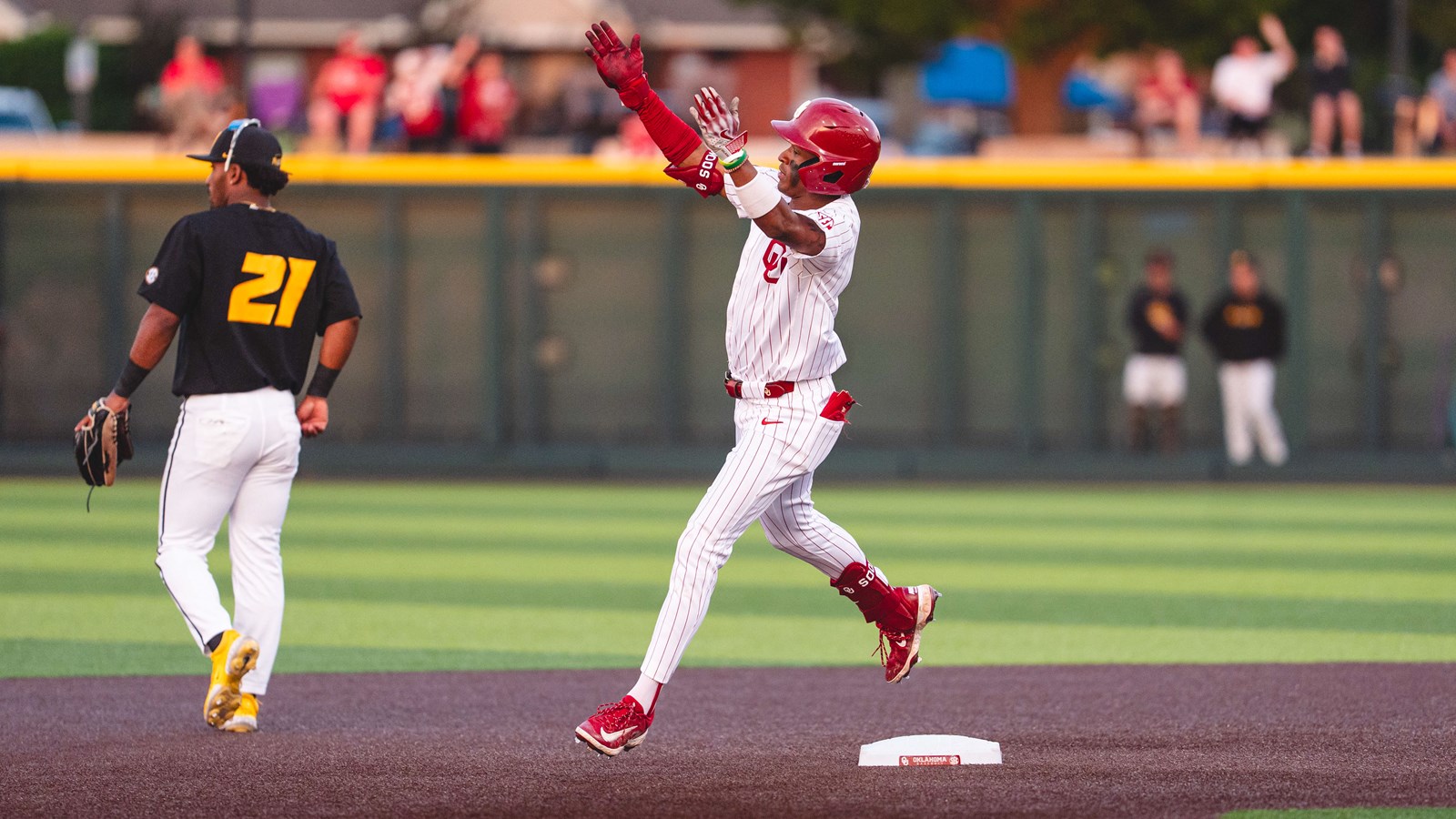Jason Walk celebrates a home run as he rounds the bases for Oklahoma