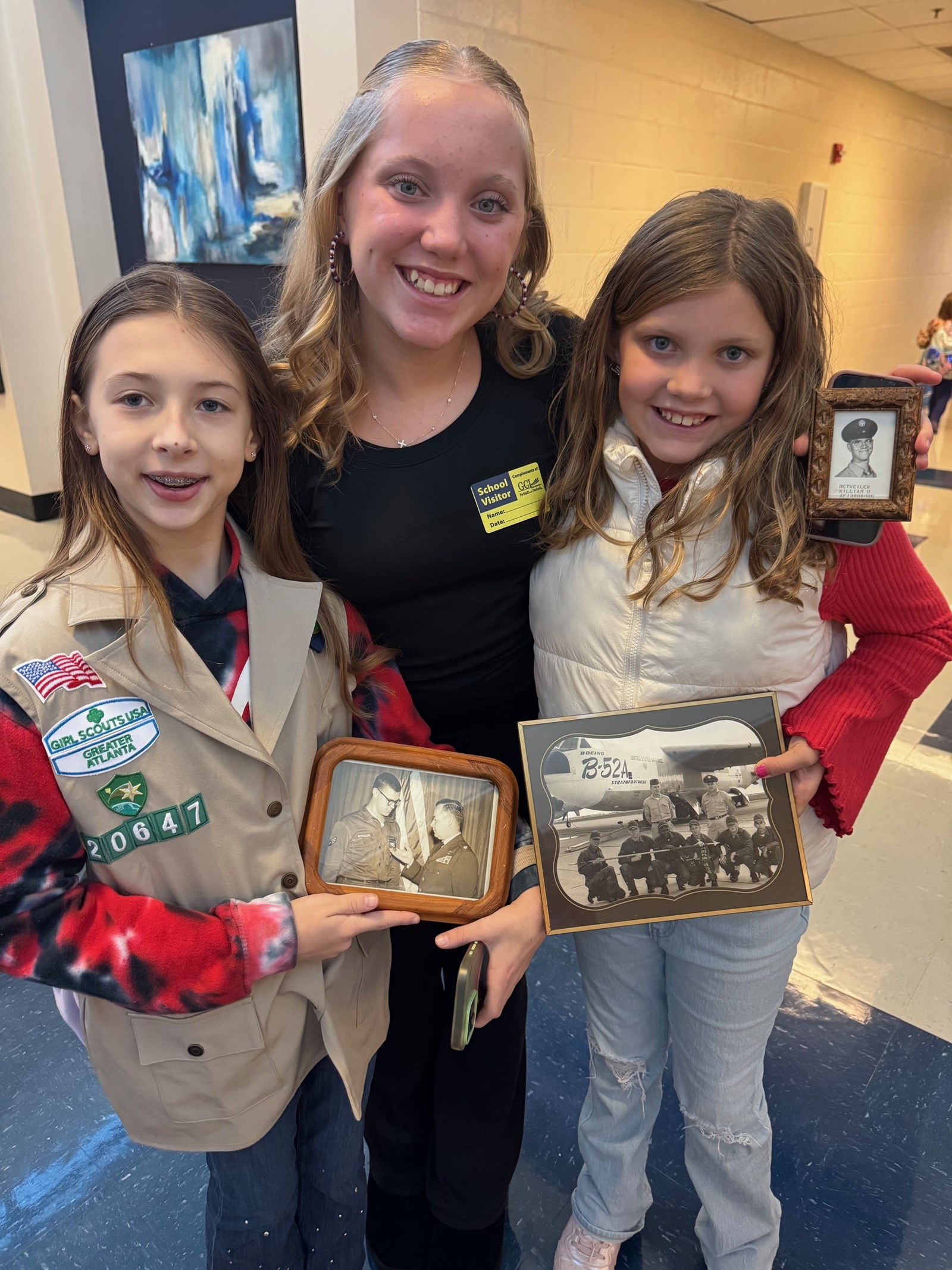 Girl Scouts with photos of vets at Keheley Elementary 