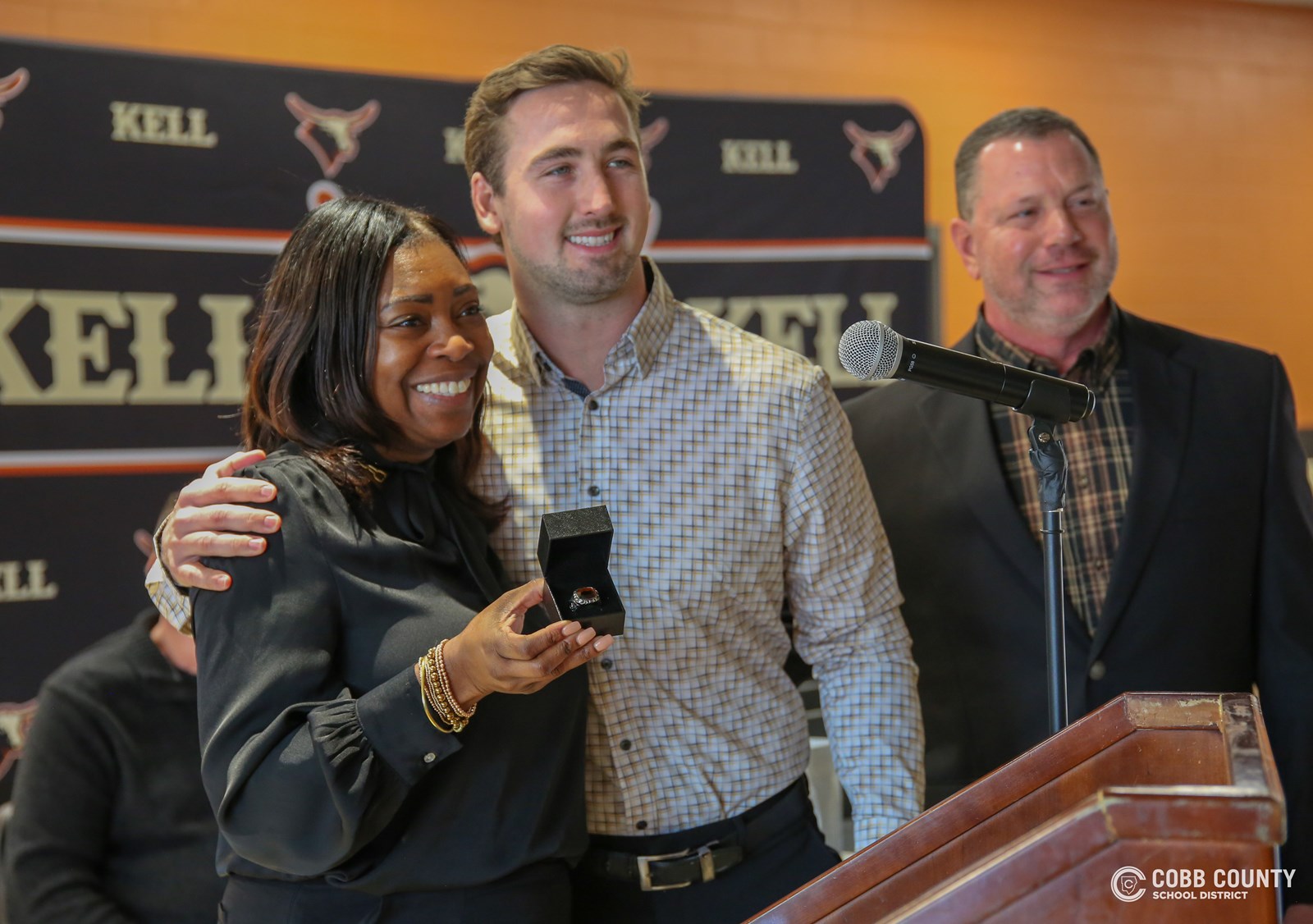 AD Oneisha Young, Bryson, and Coach Cook