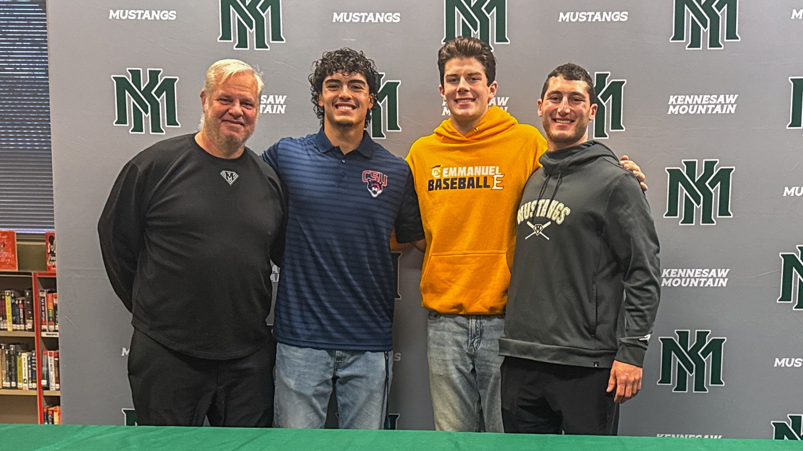 Kennesaw Mountain signees pose with their baseball coaches.
