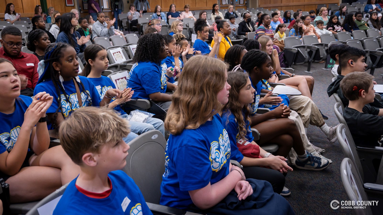 Cobb Schools students presenting speeches about community and belonging at DHH event