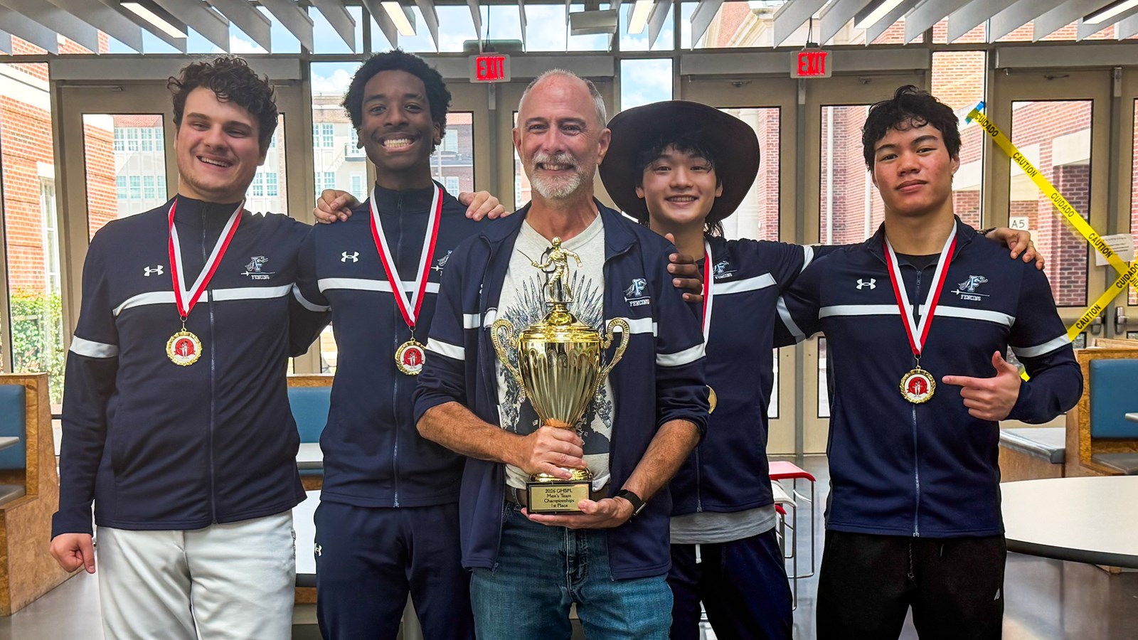 Joshua Riggins and the Pope fencing club pose with the trophy after winning the 2025-2026 GHSFL state title