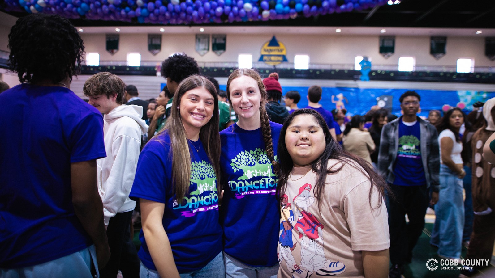 Students and volunteers dancing together at the Cobb Schools Special Education Dance.