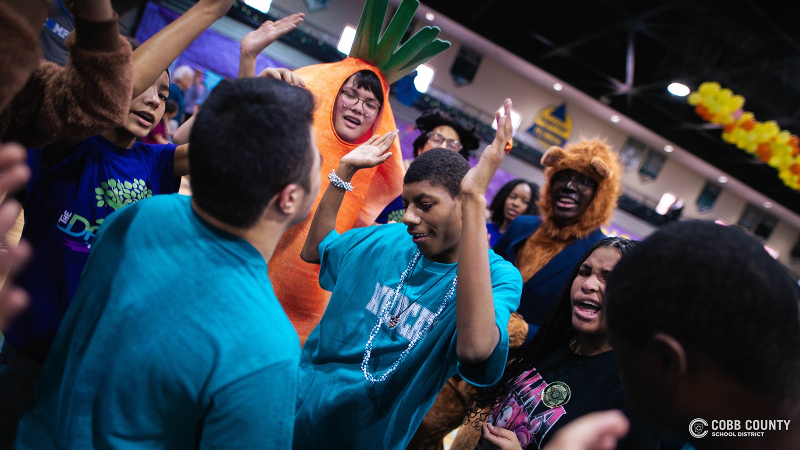 Students and volunteers dancing together at the Cobb Schools Special Education Dance.