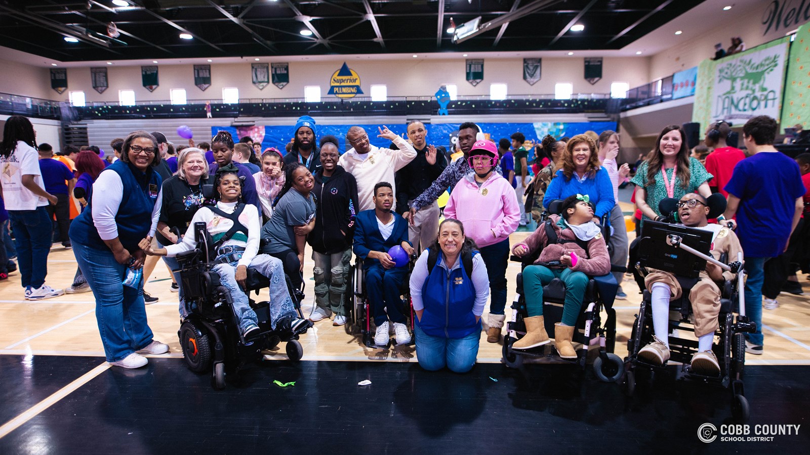 Students and volunteers dancing together at the Cobb Schools Special Education Dance.
