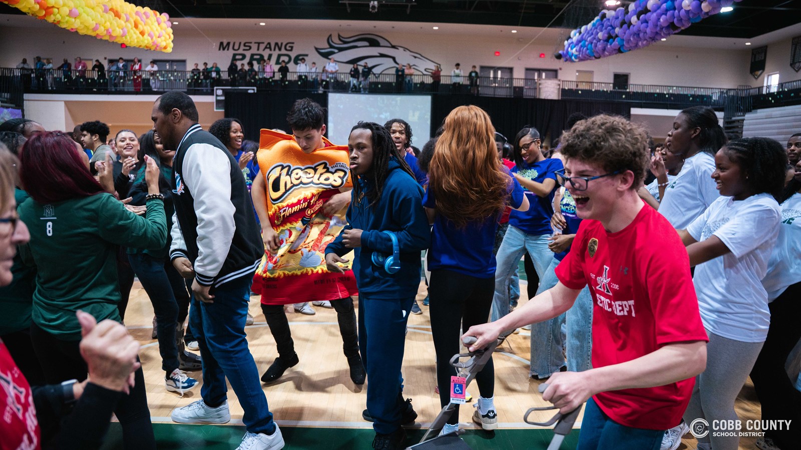 Students and volunteers dancing together at the Cobb Schools Special Education Dance.