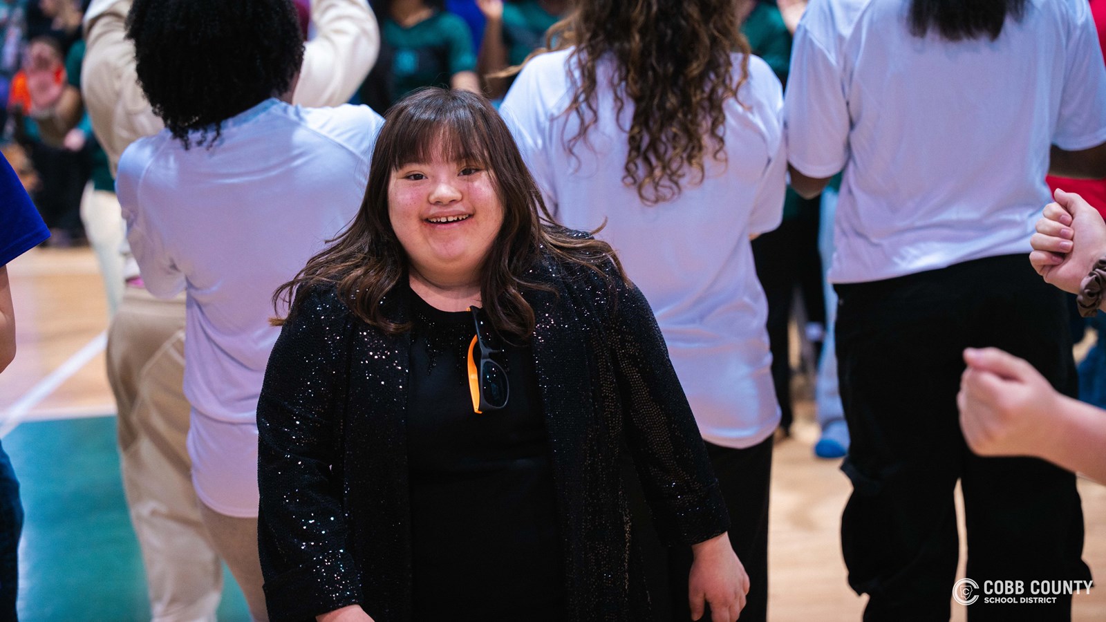 Students and volunteers dancing together at the Cobb Schools Special Education Dance.