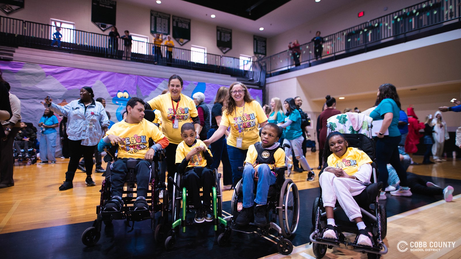 Students and volunteers dancing together at the Cobb Schools Special Education Dance.