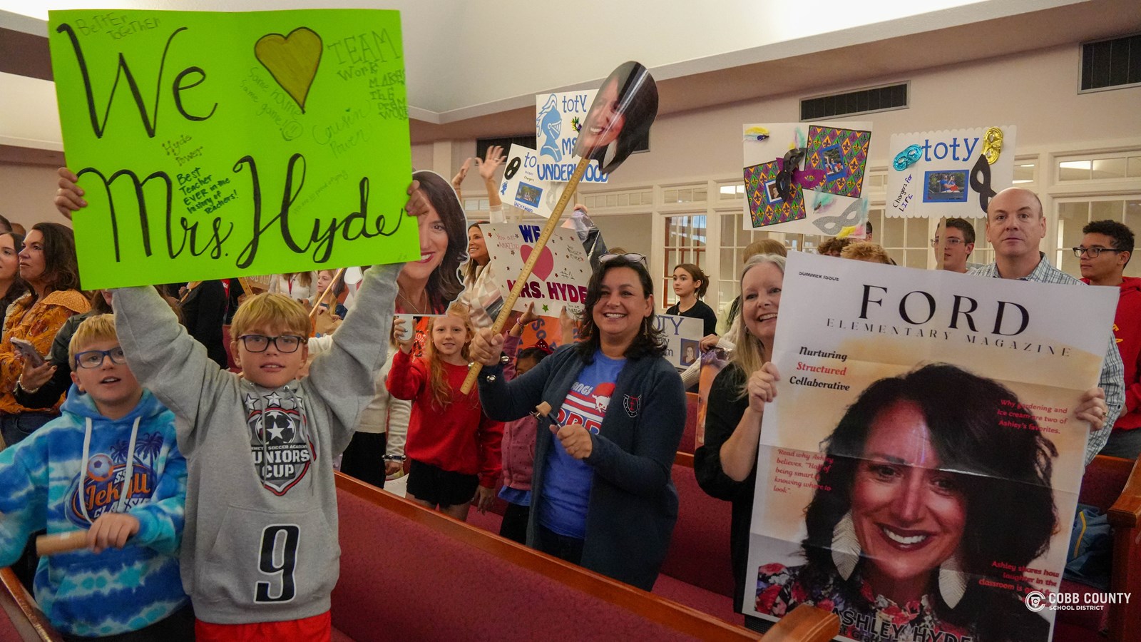 Students holding signs at pep rally